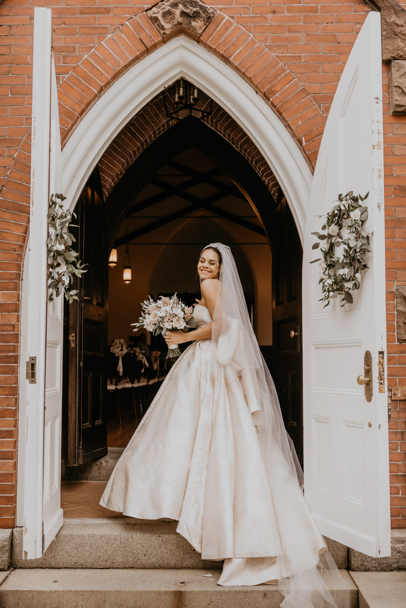 Portrait of a bride standing in the doorway of a historic Boston church